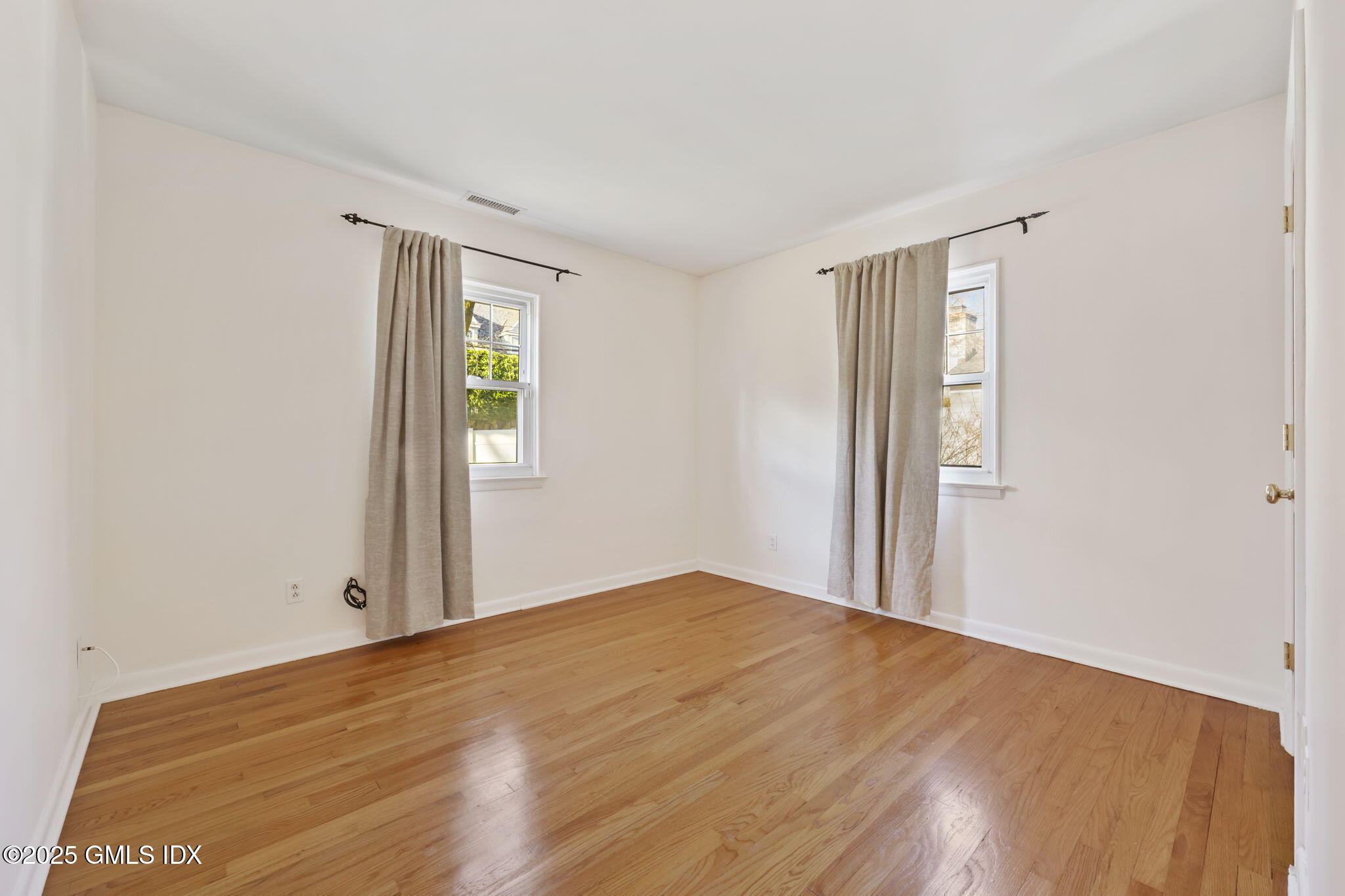 53 Midbrook Lane Old Greenwich, CT 06870 - Photo 24 of 39 a view of an empty room with wooden floor and a window