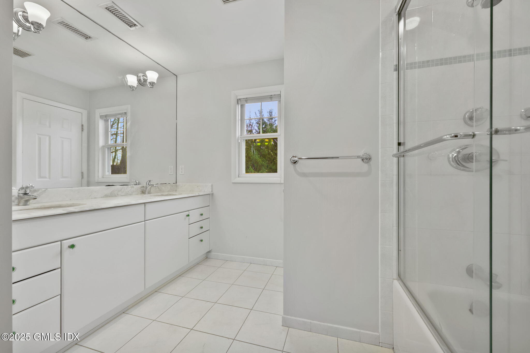 53 Midbrook Lane Old Greenwich, CT 06870 - Photo 25 of 39 a spacious bathroom with a granite countertop sink a mirror and a shower