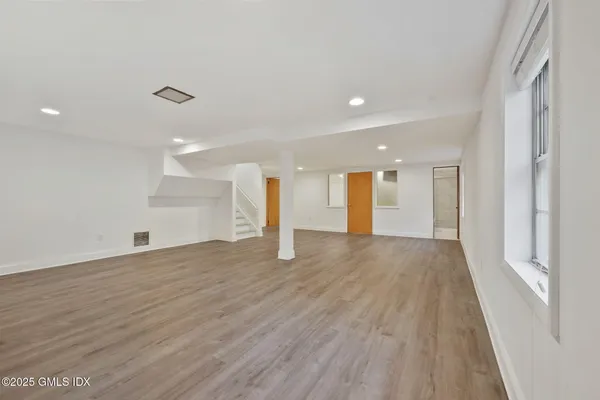 a view of an empty room with wooden floor