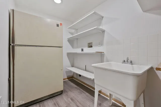 a utility room with sink dryer and washer