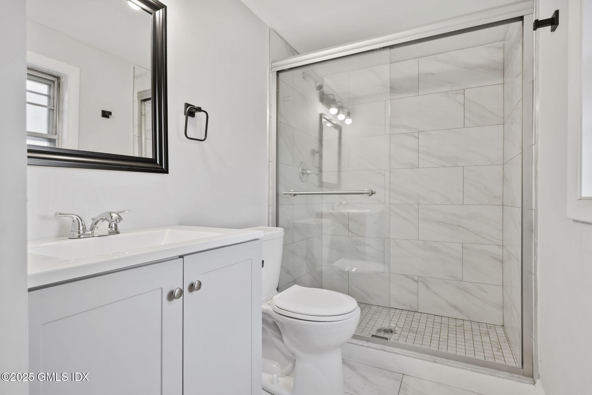 53 Midbrook Lane Old Greenwich, CT 06870 - Photo 33 of 39 a bathroom with a shower sink vanity mirror and toilet