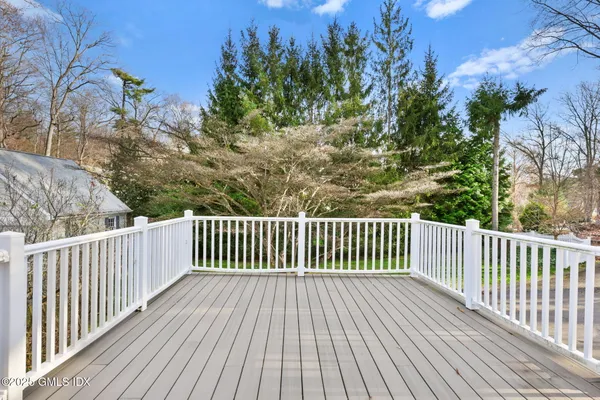a view of backyard with deck and wooden floor