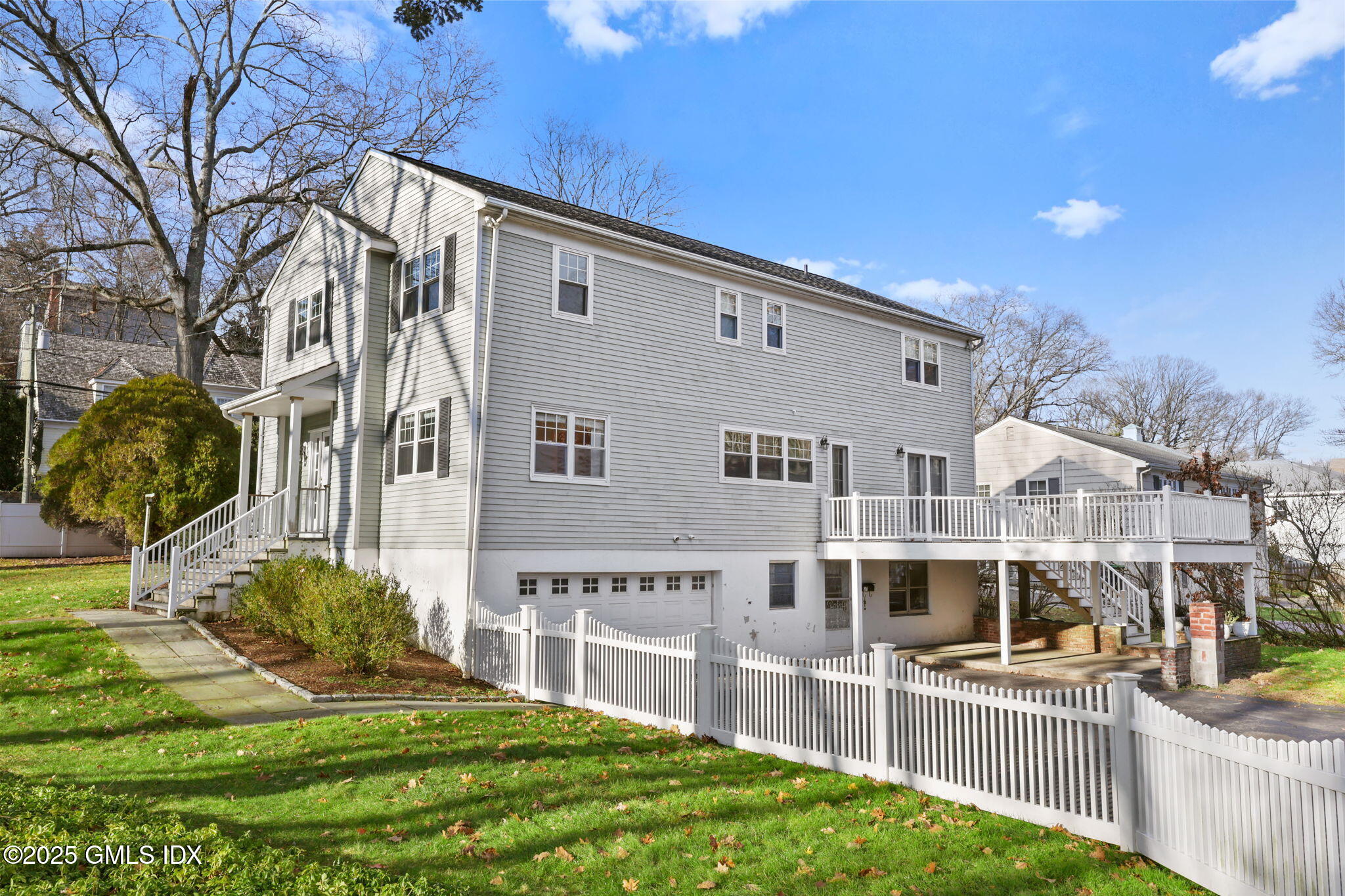 53 Midbrook Lane Old Greenwich, CT 06870 - Photo 37 of 39 a front view of a house with a yard