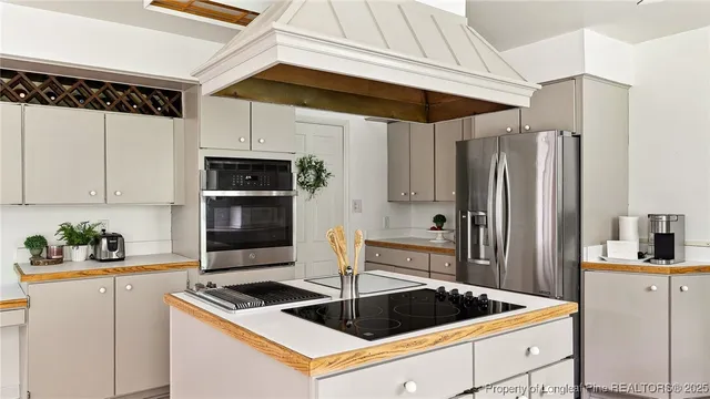 a kitchen with a sink chairs and cabinets