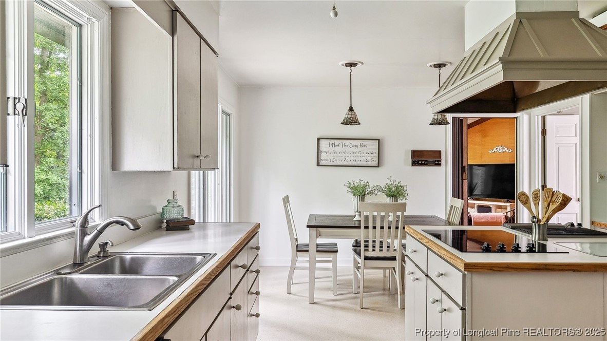 1855 Riverside Boulevard Lumberton, NC 28358 - Photo 12 of 50 a kitchen with a sink chairs and cabinets