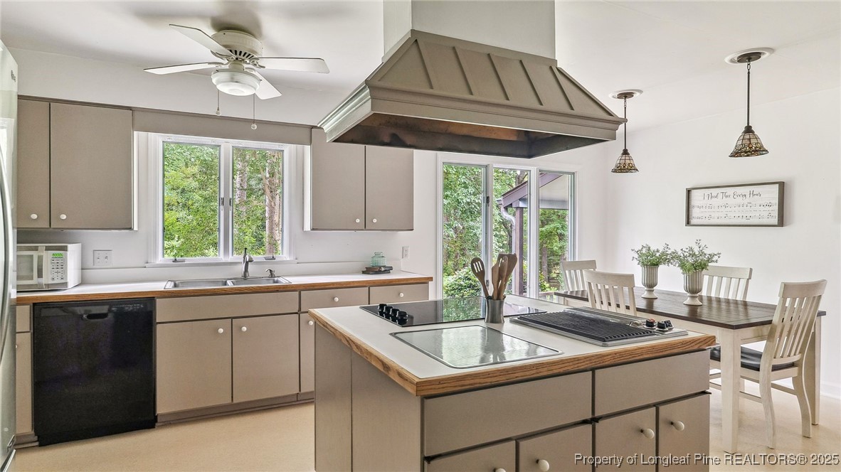 1855 Riverside Boulevard Lumberton, NC 28358 - Photo 14 of 50 a kitchen with a stove a sink a window and cabinets