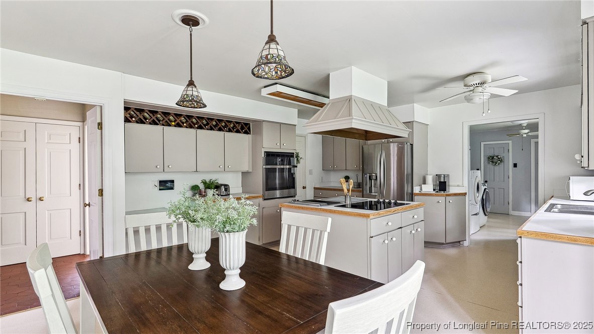 1855 Riverside Boulevard Lumberton, NC 28358 - Photo 16 of 50 a kitchen with stainless steel appliances kitchen island granite countertop a stove a sink and a refrigerator