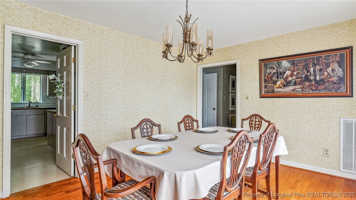 1855 Riverside Boulevard Lumberton, NC 28358 - Photo 18 of 50 a view of a dining room with furniture and wooden floor