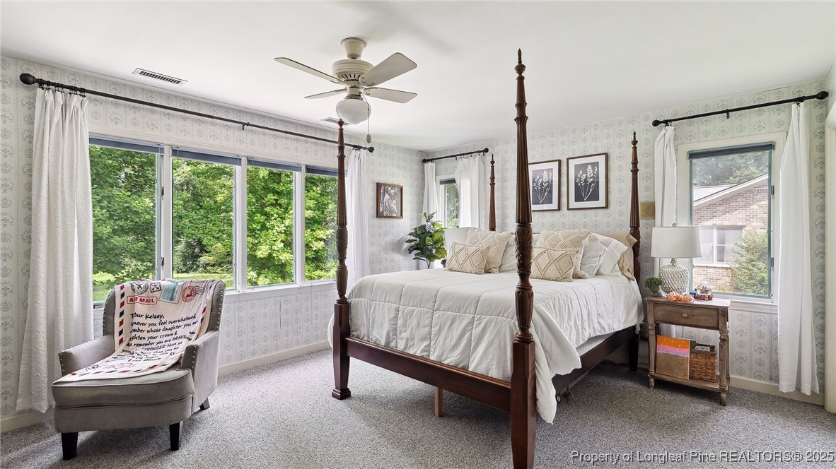 1855 Riverside Boulevard Lumberton, NC 28358 - Photo 19 of 50 a bedroom with a bed a chandelier and a window