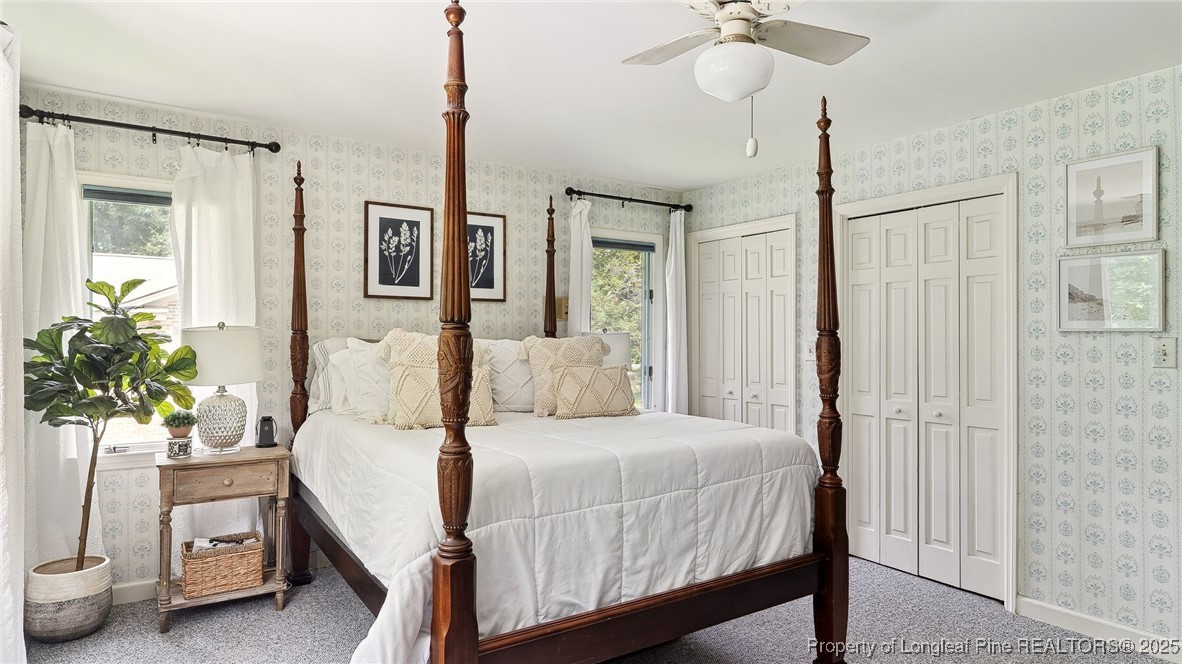 1855 Riverside Boulevard Lumberton, NC 28358 - Photo 20 of 50 a bedroom with a bed and a chandelier