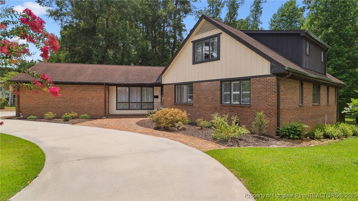 1855 Riverside Boulevard Lumberton, NC 28358 - Photo 2 of 50 a front view of a house with a garden and plants