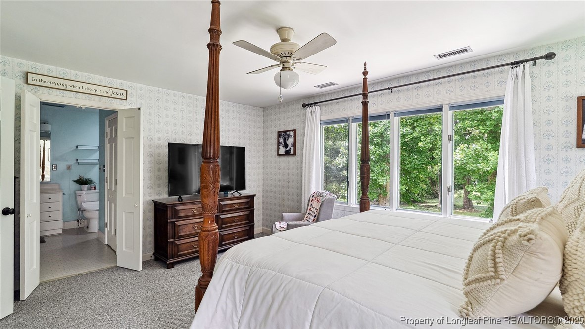 1855 Riverside Boulevard Lumberton, NC 28358 - Photo 21 of 50 a bedroom with a bed and a flat screen tv