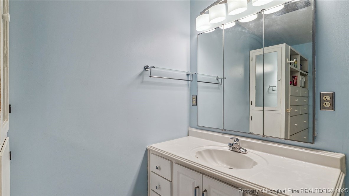 1855 Riverside Boulevard Lumberton, NC 28358 - Photo 22 of 50 a bathroom with a sink vanity granite and a mirror