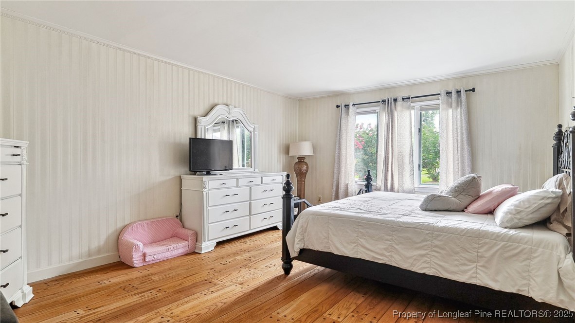 1855 Riverside Boulevard Lumberton, NC 28358 - Photo 24 of 50 a bedroom with a bed and wooden floor