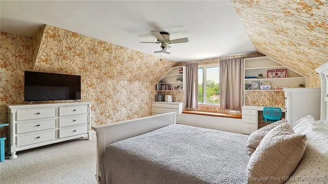 a bed sitting in a bedroom next to a window