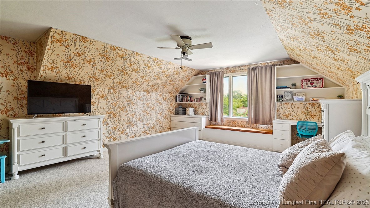 1855 Riverside Boulevard Lumberton, NC 28358 - Photo 32 of 50 a bedroom with a bed a flat screen tv and a fireplace