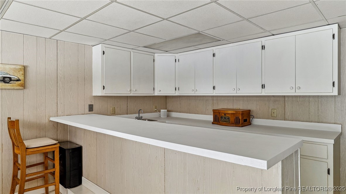 1855 Riverside Boulevard Lumberton, NC 28358 - Photo 38 of 50 a kitchen with granite countertop white cabinets and white appliances