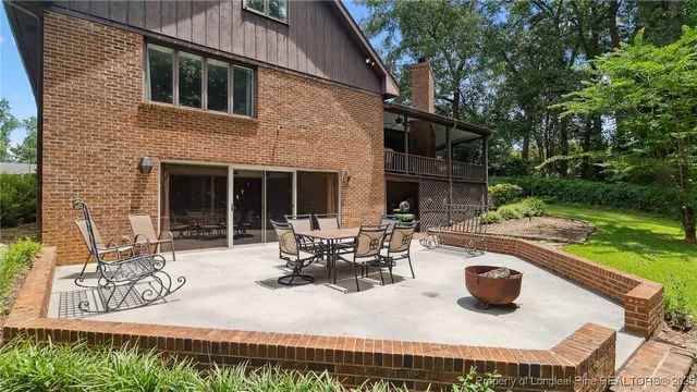 a view of a house with a yard and sitting area