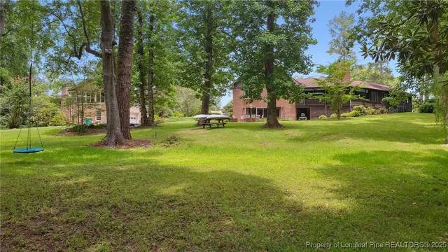 a view of a lake with a bench and trees