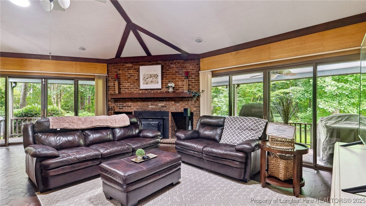 1855 Riverside Boulevard Lumberton, NC 28358 - Photo 6 of 50 a living room with furniture a flat screen tv and a floor to ceiling window