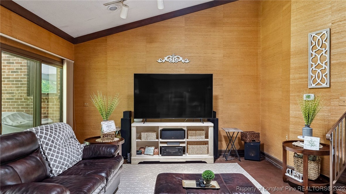 1855 Riverside Boulevard Lumberton, NC 28358 - Photo 9 of 50 a living room with furniture a flat screen tv and a fireplace