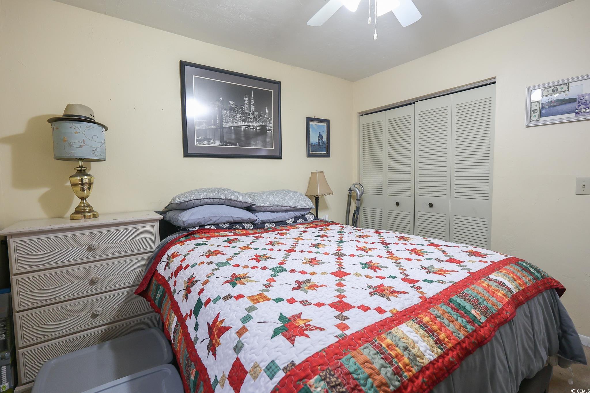 1301 Pridgen Road, Unit 1101 Myrtle Beach, SC 29577 - Photo 13 of 21 Bedroom with a closet and a ceiling fan