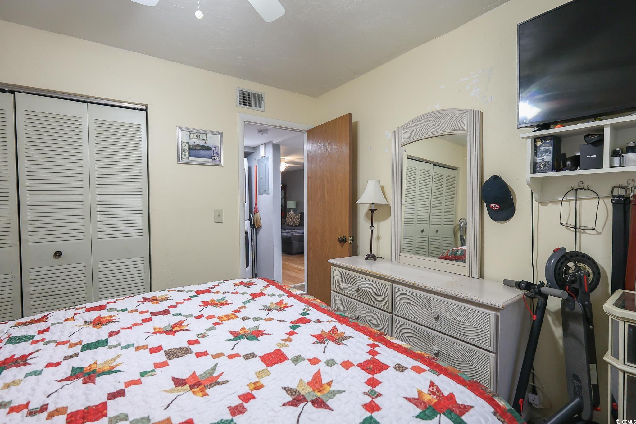 1301 Pridgen Road, Unit 1101 Myrtle Beach, SC 29577 - Photo 14 of 21 Bedroom with ceiling fan, visible vents, and a clo