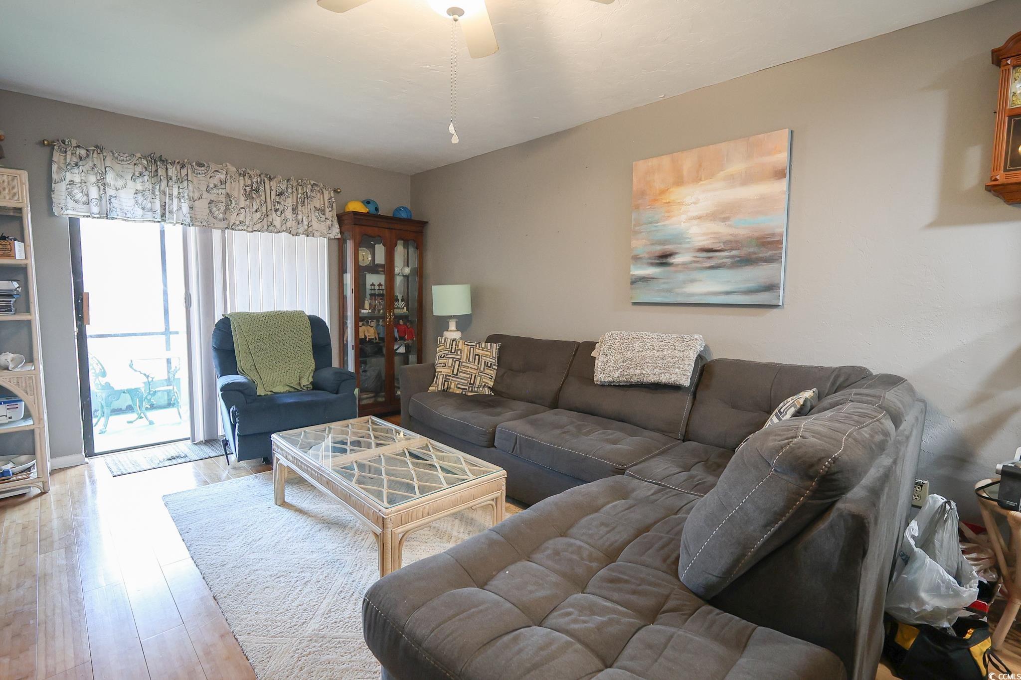 1301 Pridgen Road, Unit 1101 Myrtle Beach, SC 29577 - Photo 2 of 21 Living area featuring a ceiling fan and wood finis