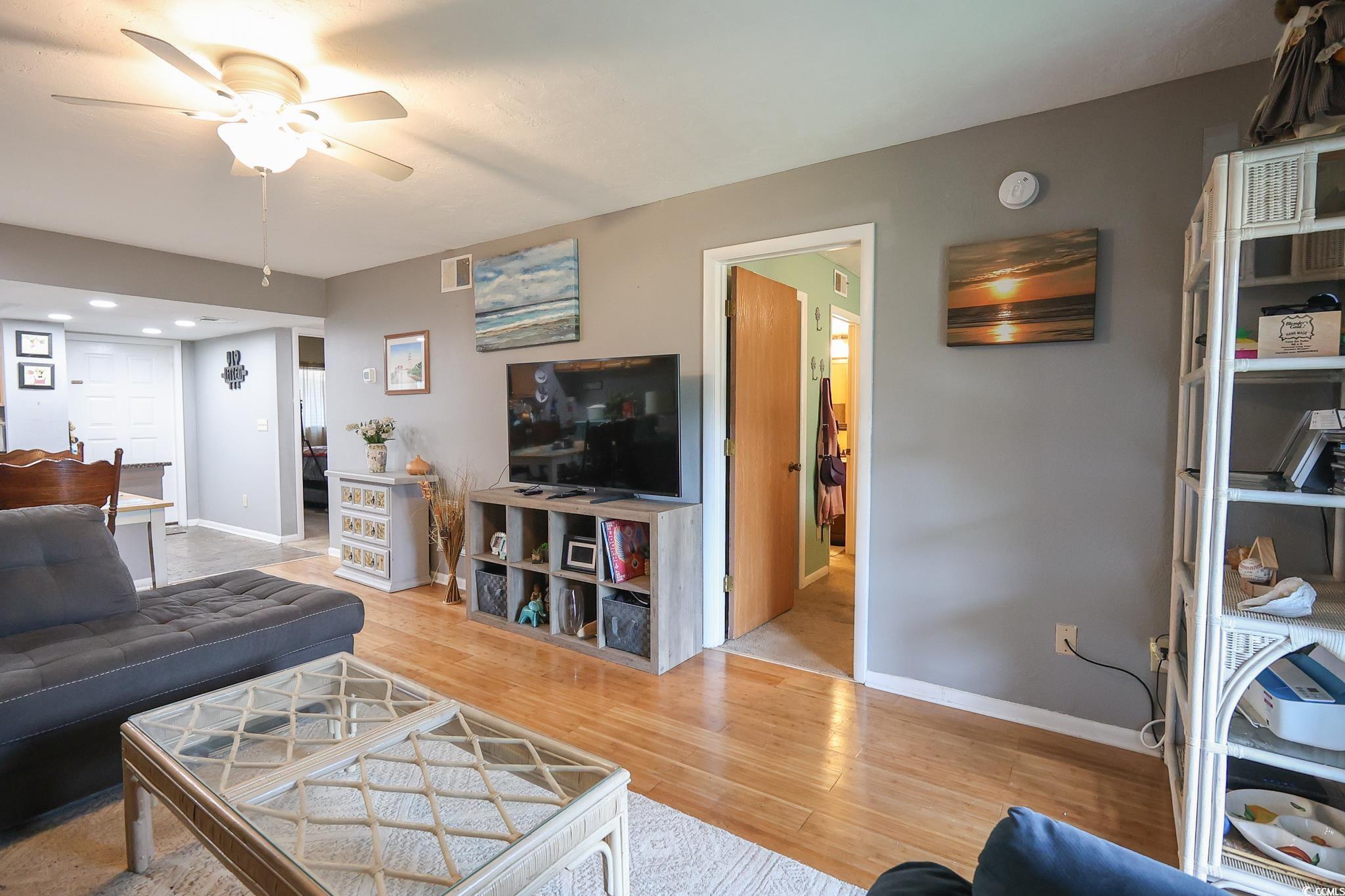 1301 Pridgen Road, Unit 1101 Myrtle Beach, SC 29577 - Photo 3 of 21 Living area featuring a ceiling fan, light wood-ty