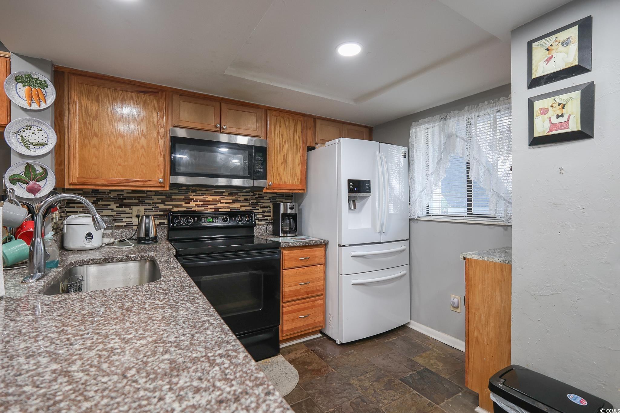 1301 Pridgen Road, Unit 1101 Myrtle Beach, SC 29577 - Photo 5 of 21 Kitchen featuring black range with electric cookto