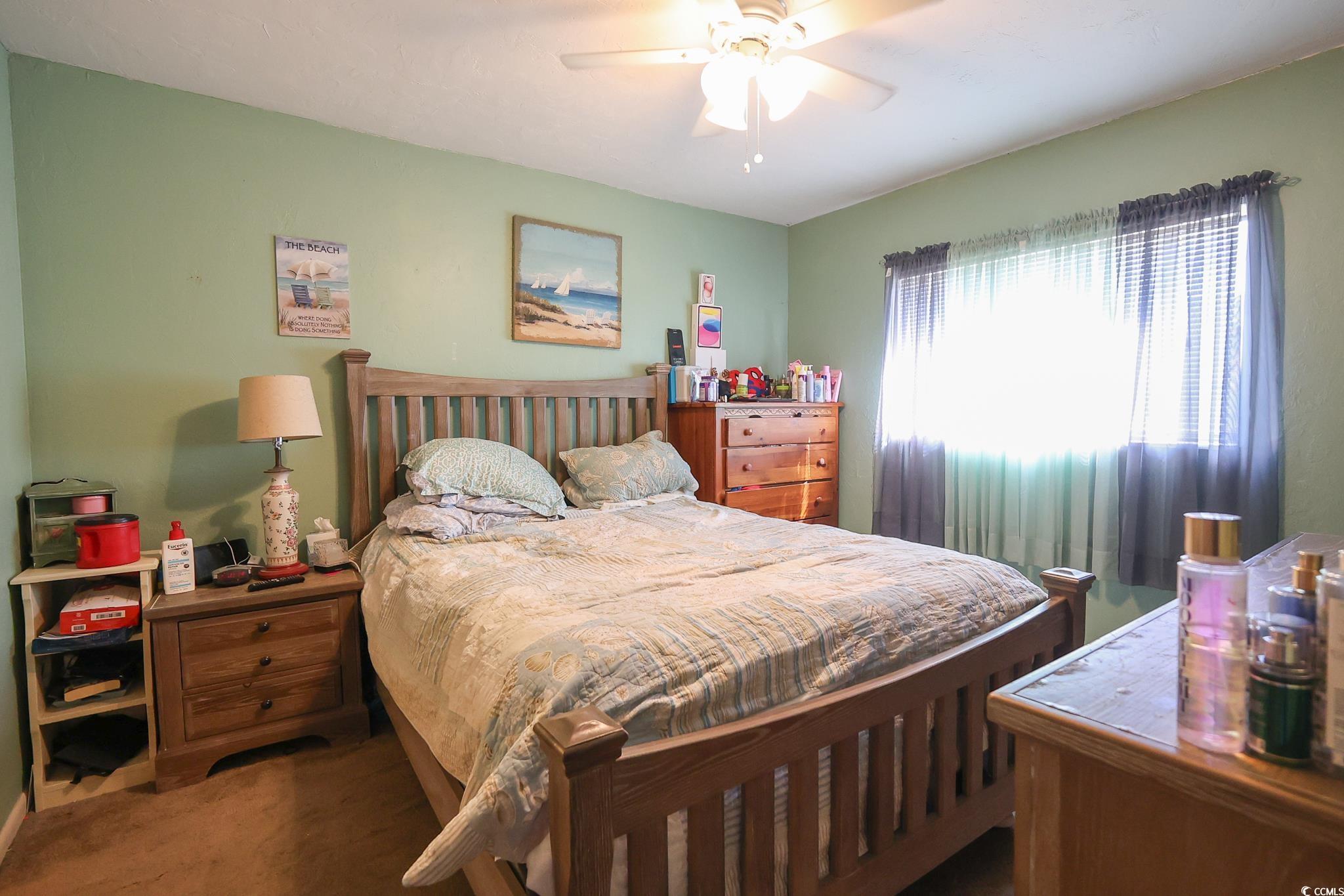 1301 Pridgen Road, Unit 1101 Myrtle Beach, SC 29577 - Photo 6 of 21 Bedroom featuring a ceiling fan and carpet