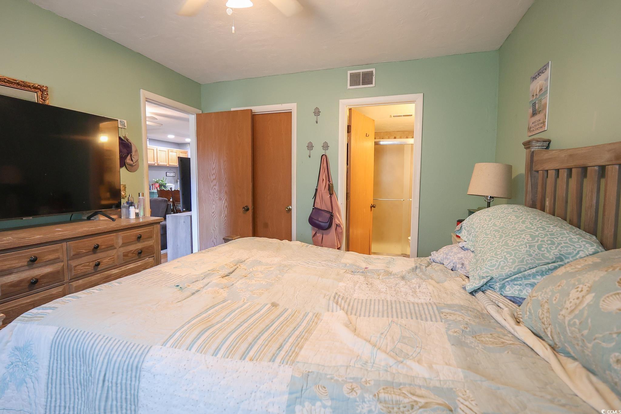 1301 Pridgen Road, Unit 1101 Myrtle Beach, SC 29577 - Photo 7 of 21 Bedroom featuring ensuite bath, visible vents, and