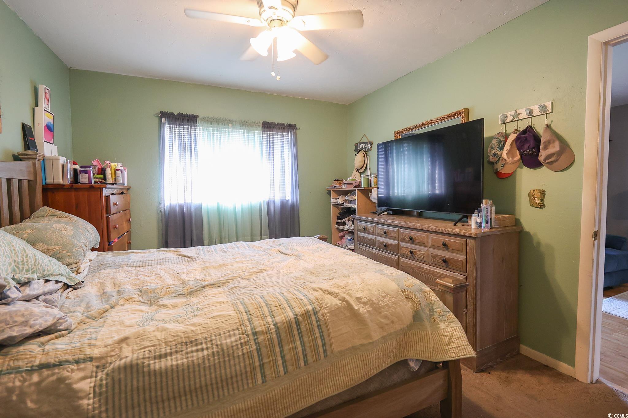 1301 Pridgen Road, Unit 1101 Myrtle Beach, SC 29577 - Photo 8 of 21 Bedroom with ceiling fan, carpet floors, and baseb