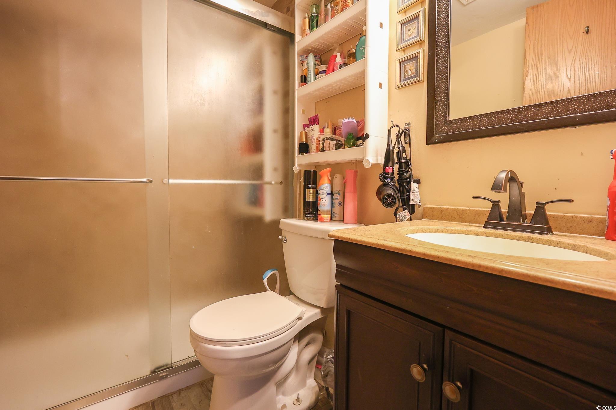 1301 Pridgen Road, Unit 1101 Myrtle Beach, SC 29577 - Photo 9 of 21 Bathroom with toilet, a stall shower, and vanity