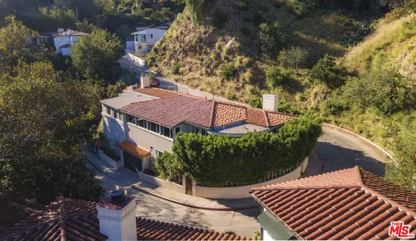 an aerial view of a house with a yard