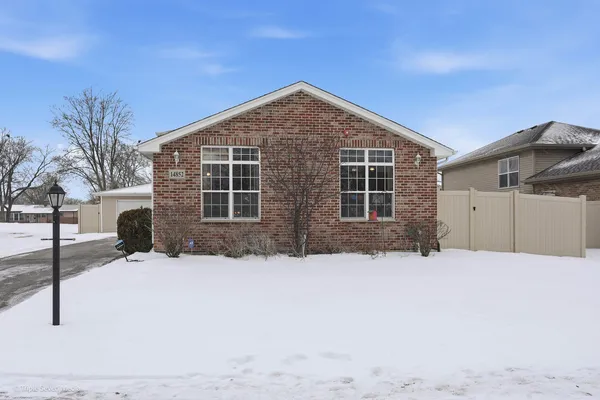 a view of house with yard and covered with snow