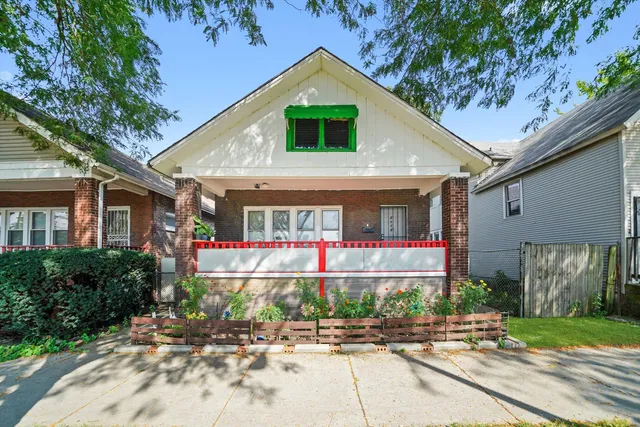 a front view of house along the path and trees