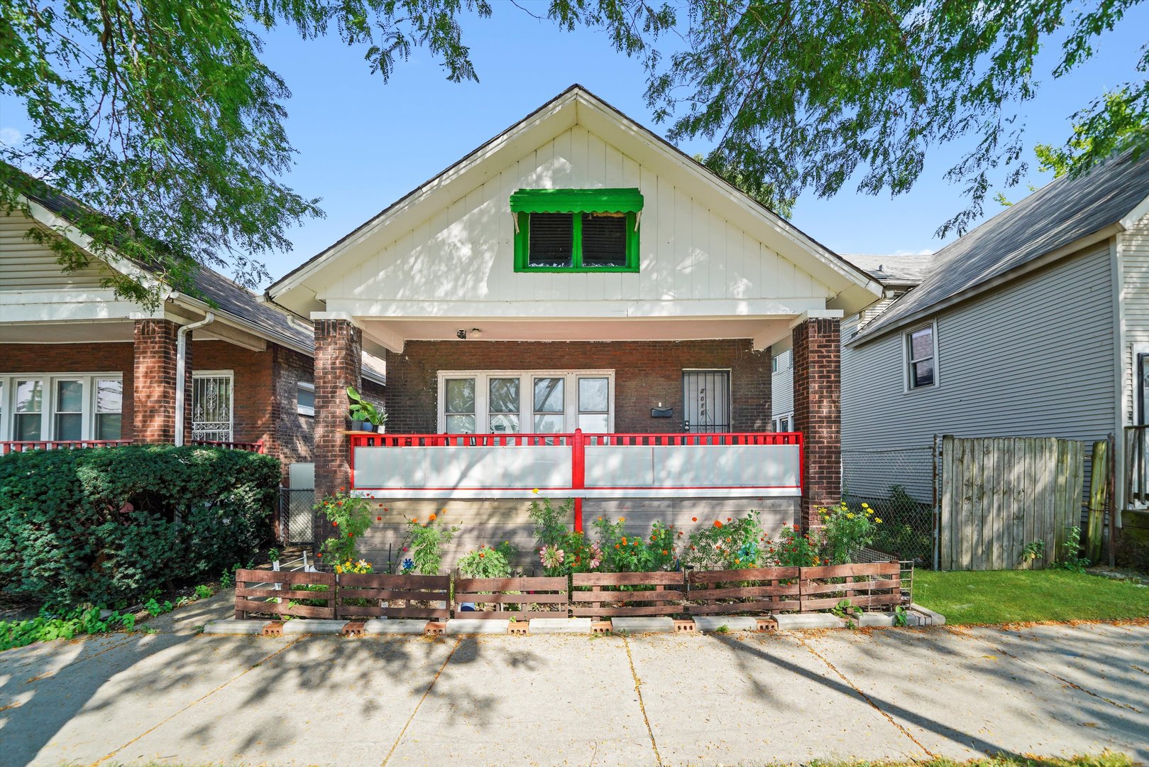 a front view of house along the path and trees