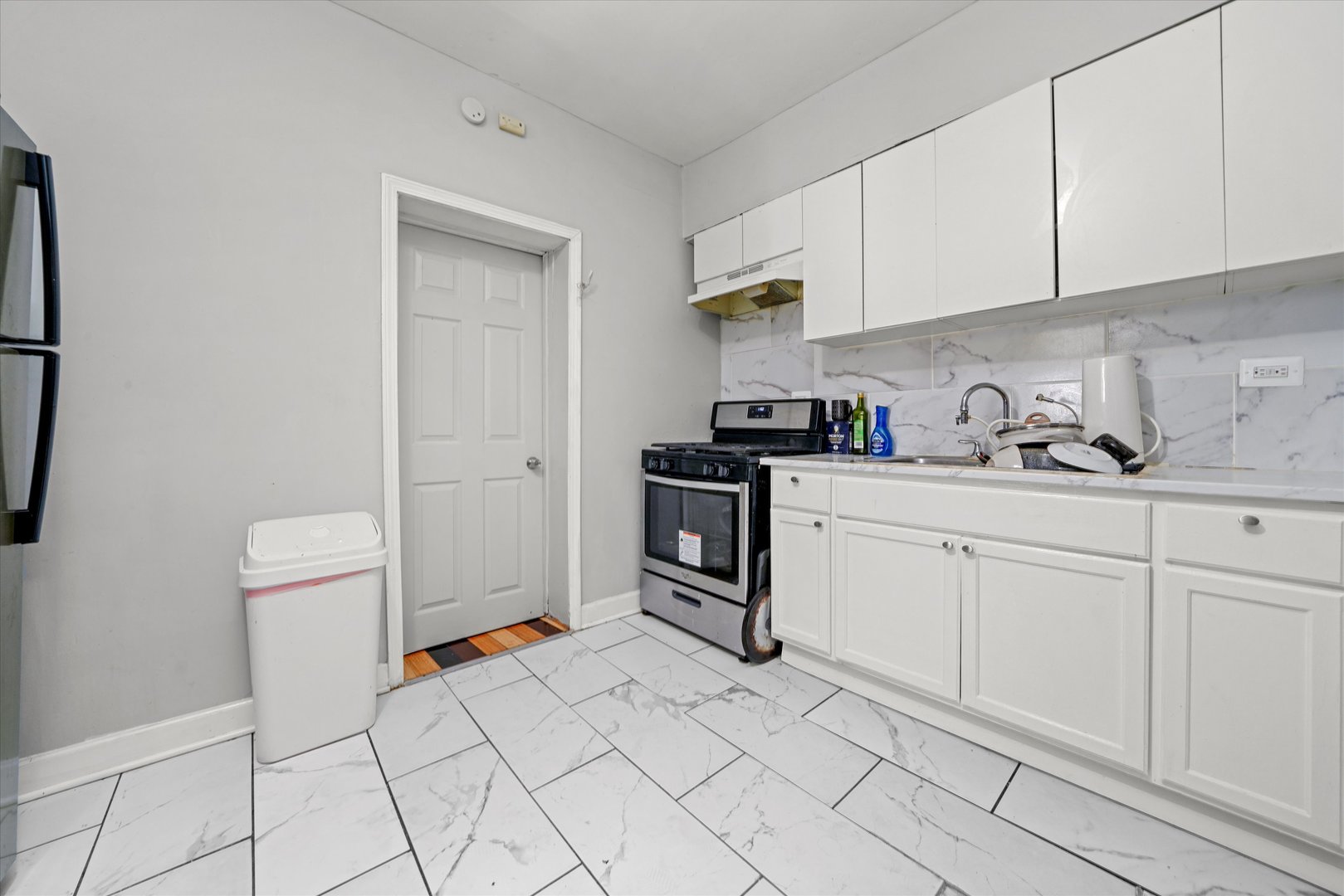 2016 East 93rd Street Chicago, IL 60617 - Photo 6 of 17 a kitchen with white cabinets and white appliances