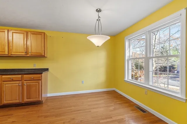 a view of a kitchen with wooden floor and chandelier