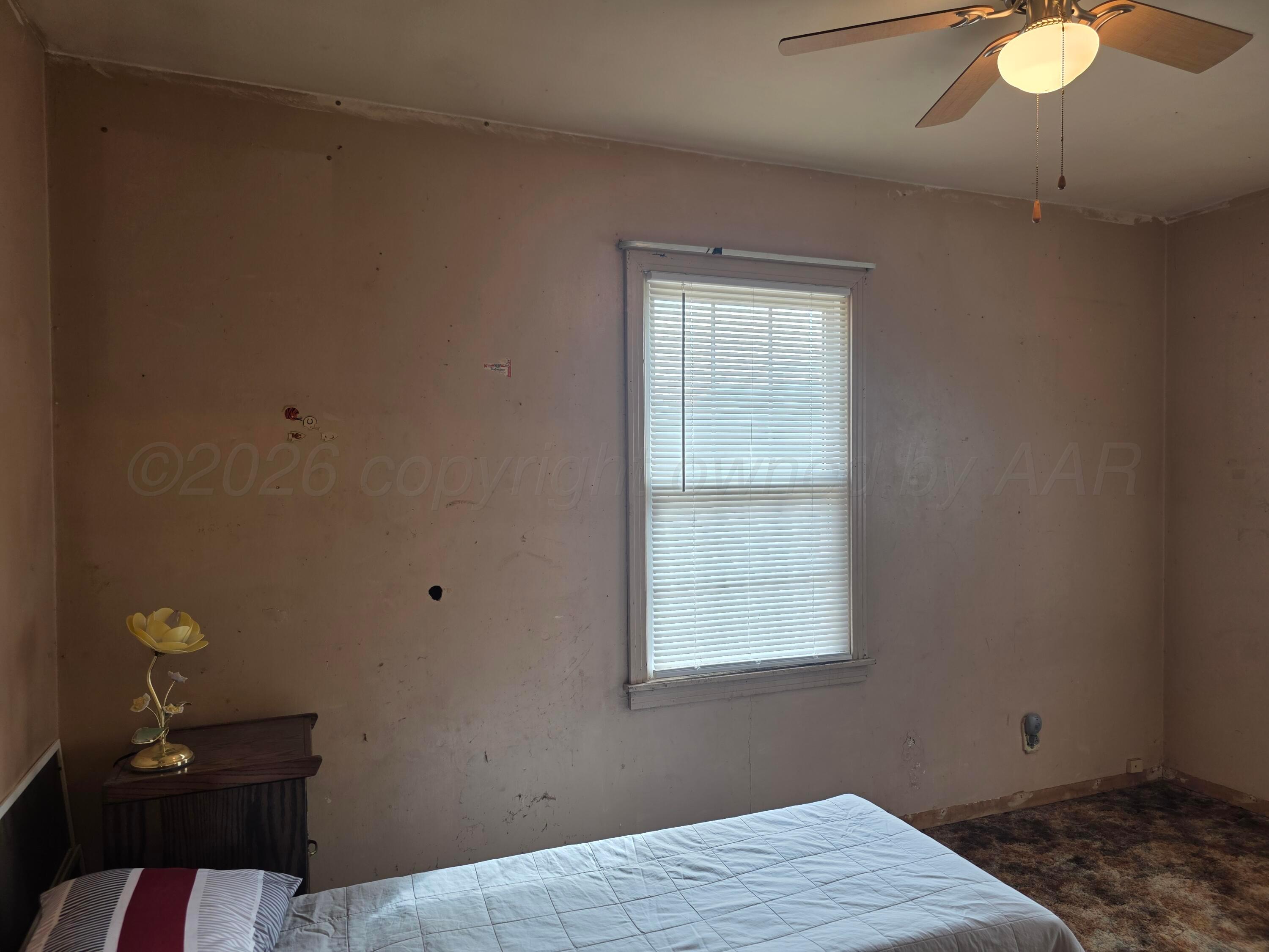1812 Magnolia Street Amarillo, TX 79107 - Photo 14 of 27 a bedroom with a bed and window