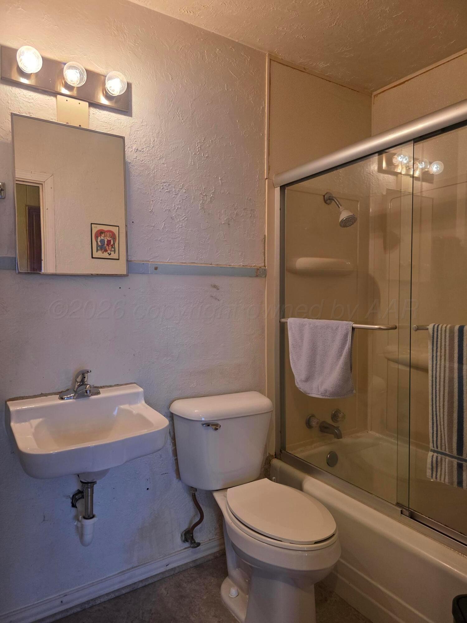 1812 Magnolia Street Amarillo, TX 79107 - Photo 16 of 27 a bathroom with a sink a toilet and shower