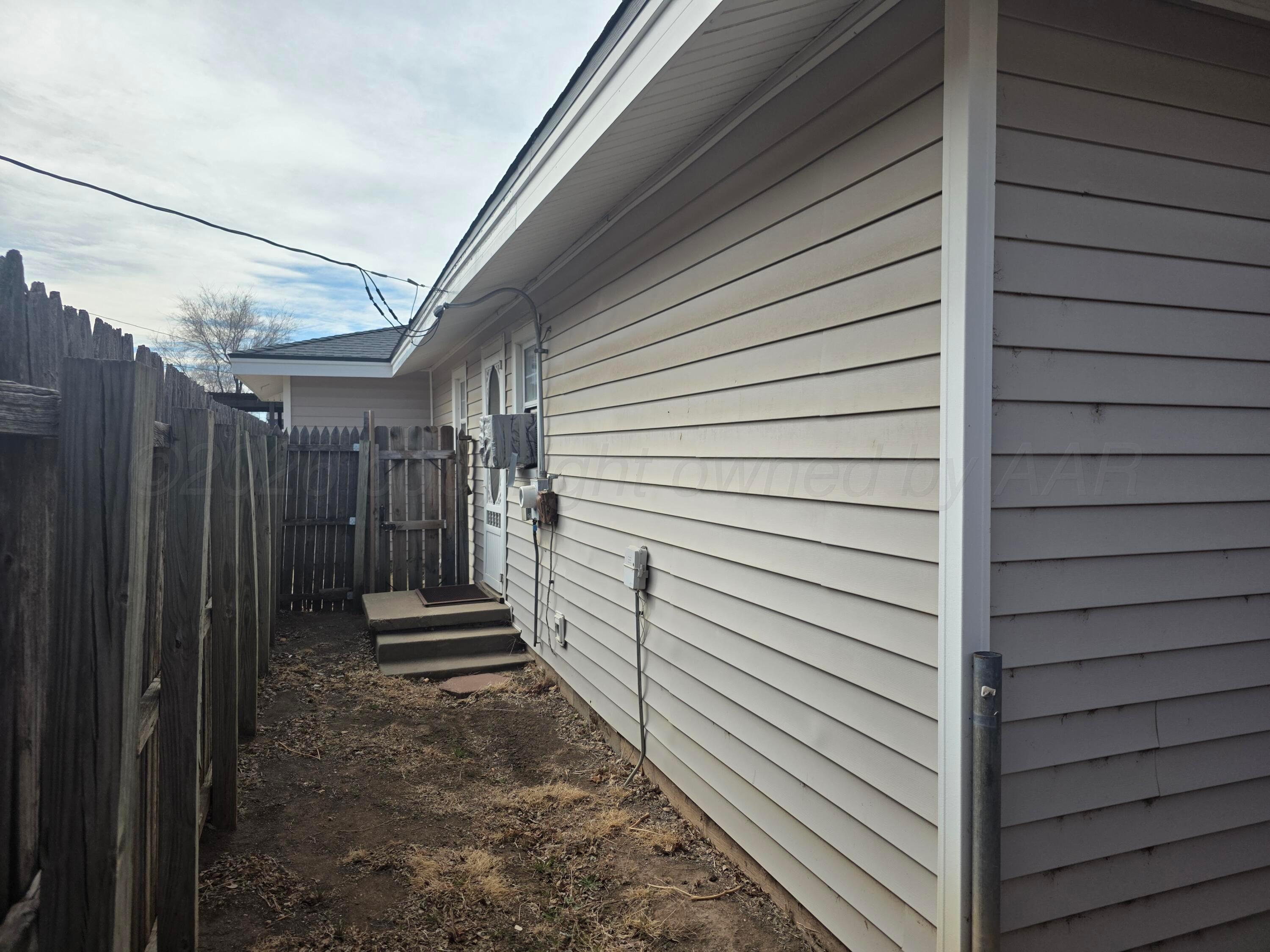 1812 Magnolia Street Amarillo, TX 79107 - Photo 21 of 27 a view of a house with a door and wooden walls