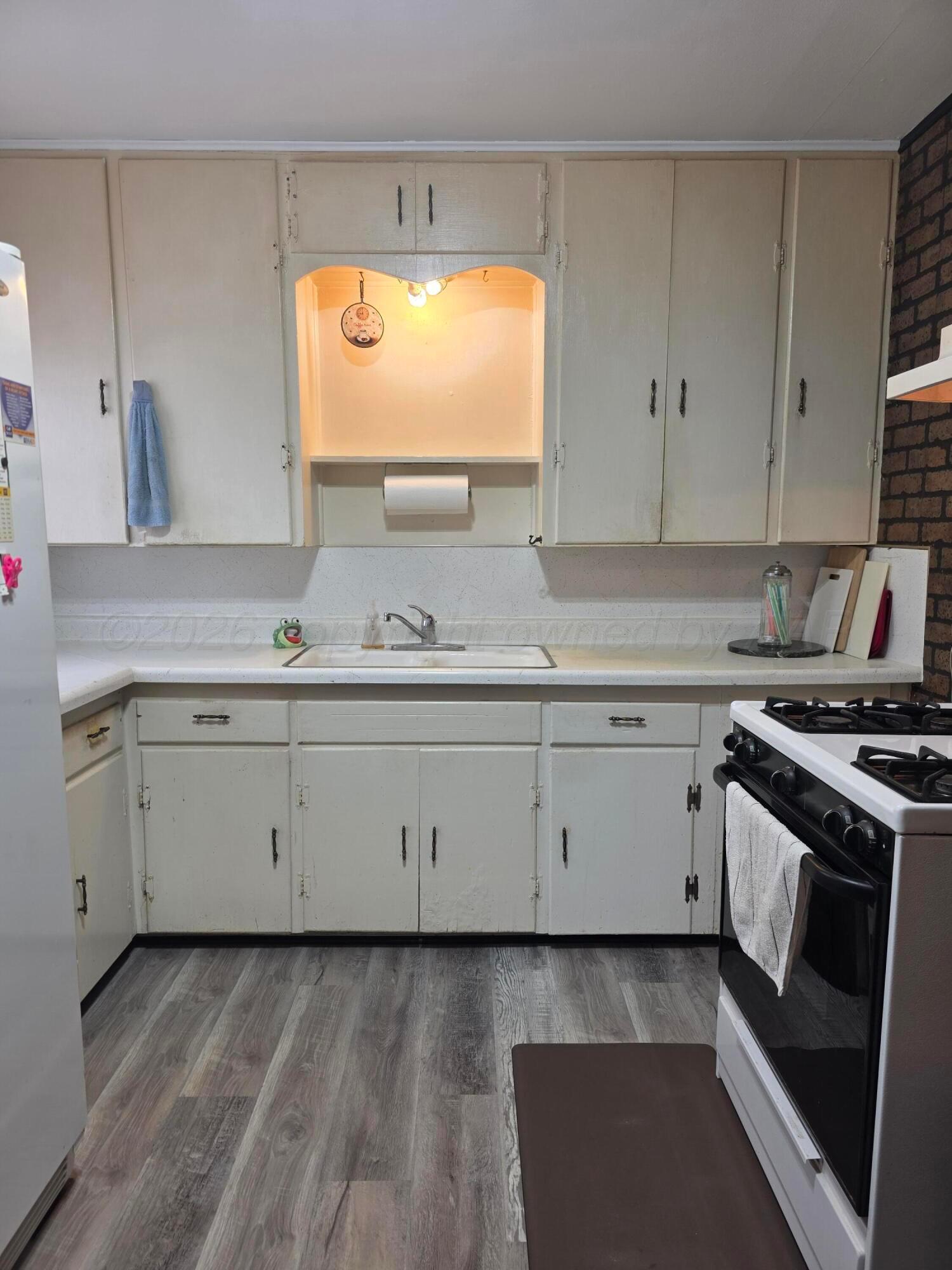 1812 Magnolia Street Amarillo, TX 79107 - Photo 7 of 27 a kitchen with granite countertop white cabinets and a stove