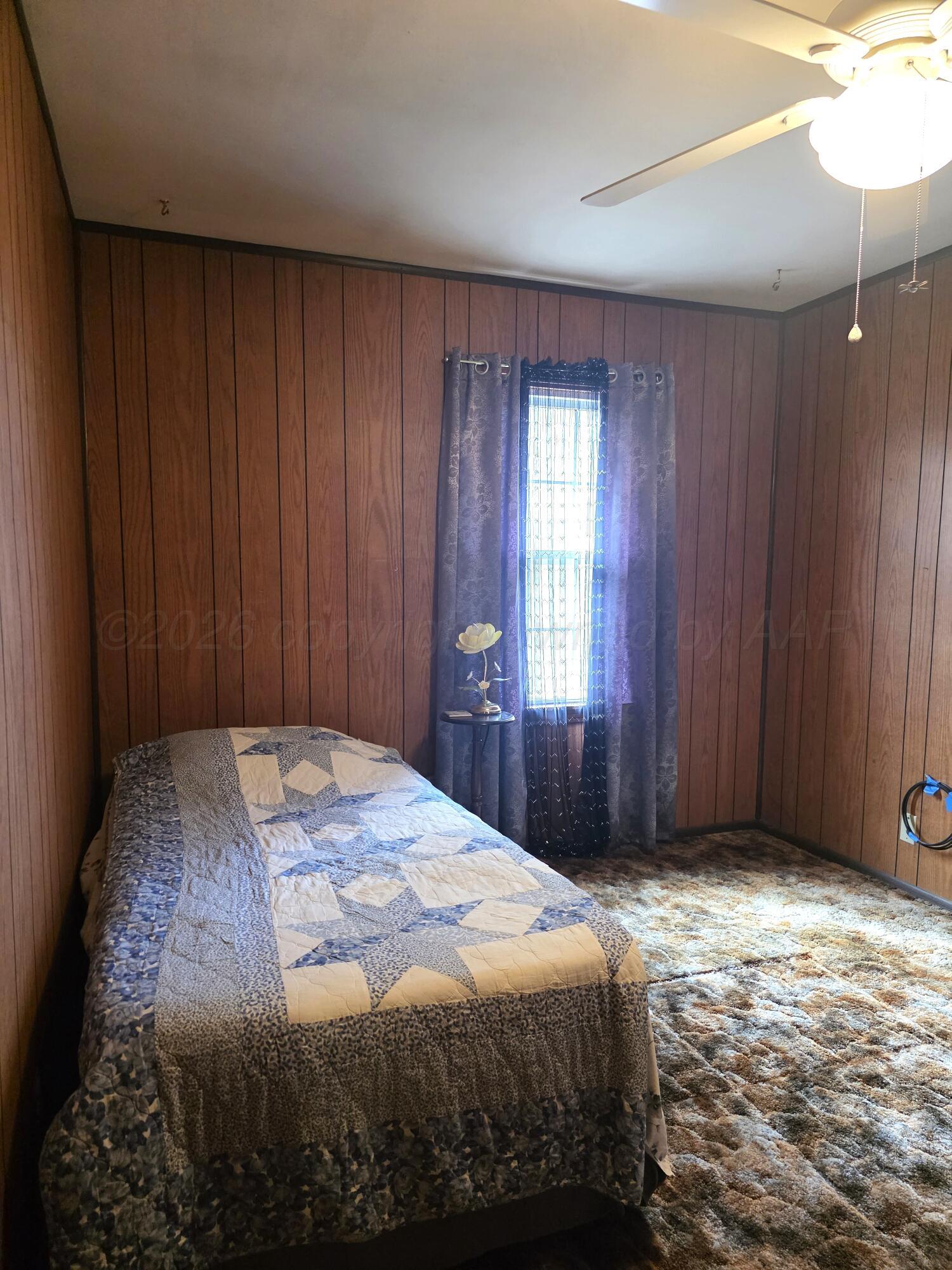 1812 Magnolia Street Amarillo, TX 79107 - Photo 10 of 27 a bedroom with a bed and a window