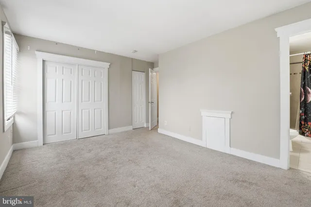 a view of an empty room and a window