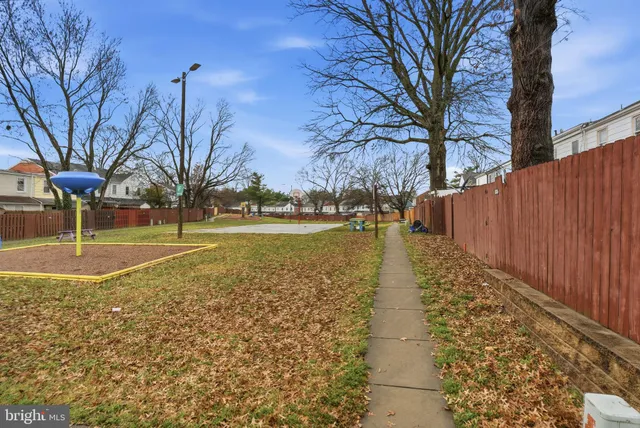 a view of a yard with wooden fence