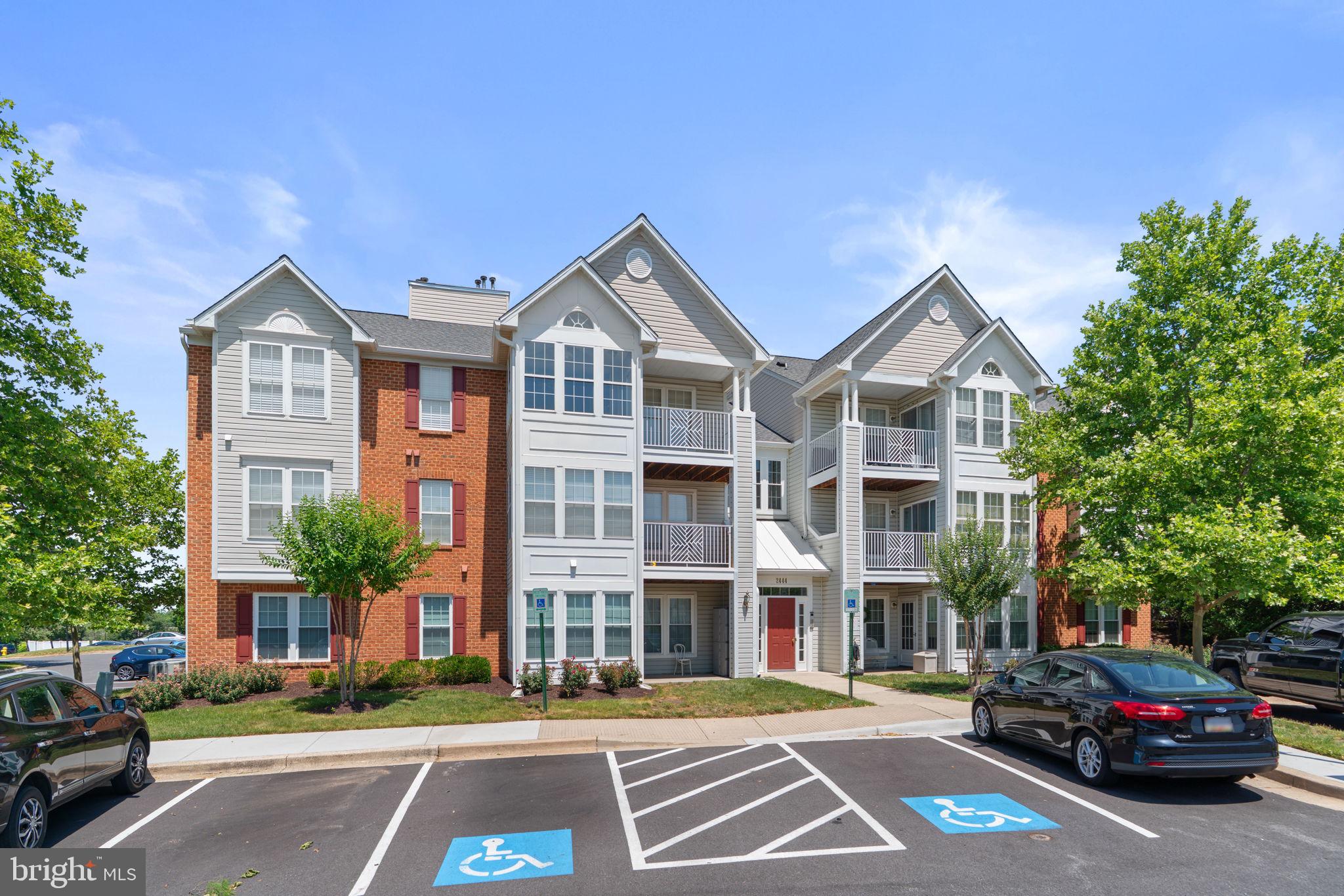 2444 Blue Spring Court, Unit 203 Odenton, MD 21113 - Photo 36 of 36 a city street lined with buildings and cars