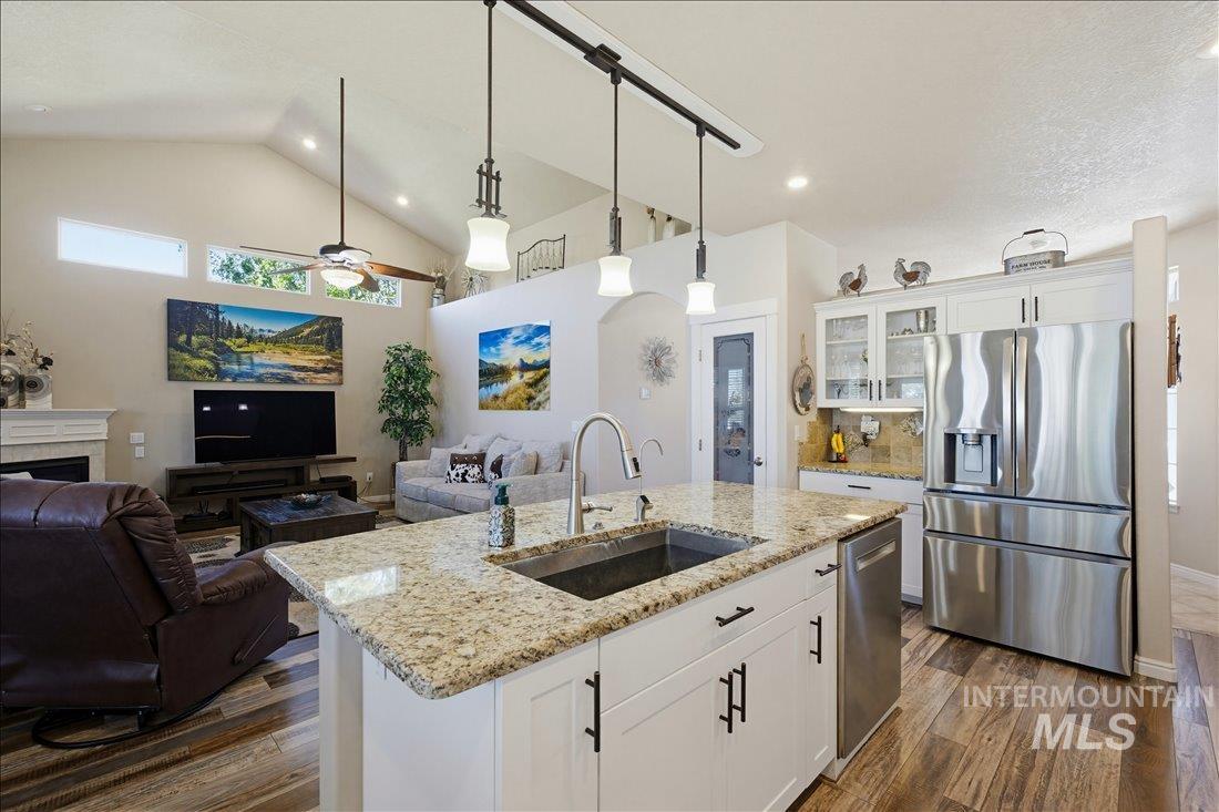 24623 Falcon Lane Caldwell, ID 83607 - Photo 12 of 40 Kitchen island with a stainless steel sink and granite countertop