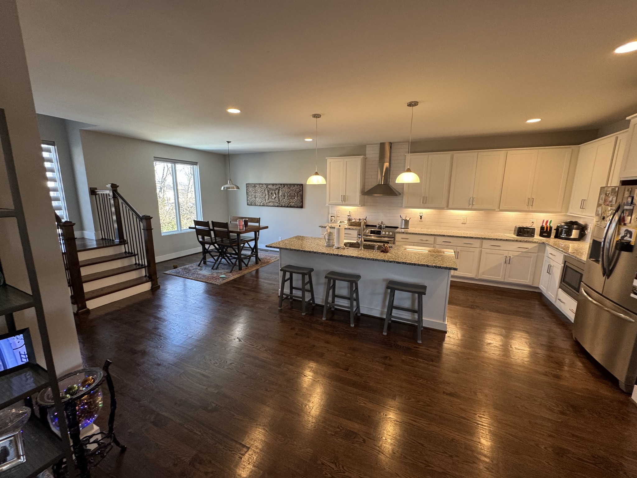 40 Hubbard Street Nashville, TN 37210 - Photo 16 of 96 a kitchen with stainless steel appliances granite countertop a stove top oven a dining table and chairs with wooden floor